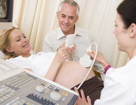 SMWC - woman getting ultrasound from doctor with husband