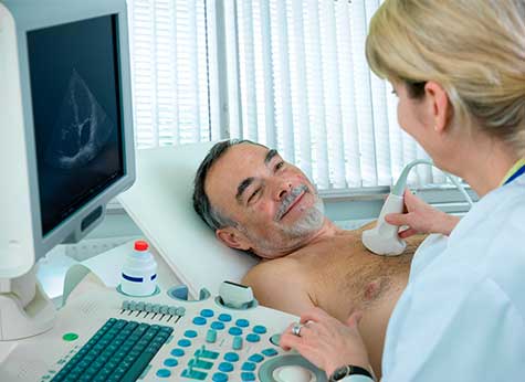 SMWC - Doctor is using ultrasound machine to scan the heart of a senior male patient