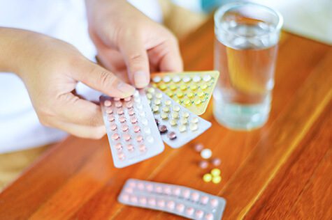 SMWC - holding contraception pills in hand